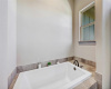 The primary bathroom has both a walk-in shower as well as a huge soaking tub.