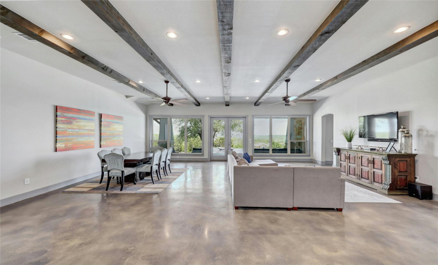 Polished concrete floors are known to be extremely energy efficient and improve natural light making a home more beautiful and keeping costs low. Notice the combined living and dining space which keeps the whole family united!