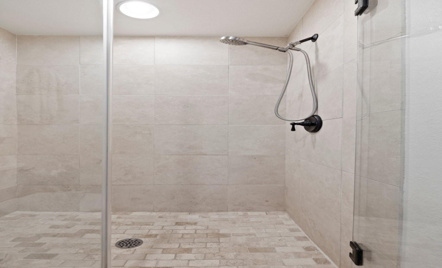 The separate walk-in shower provides a luxurious experience, completing the spa-like atmosphere of the primary bathroom.