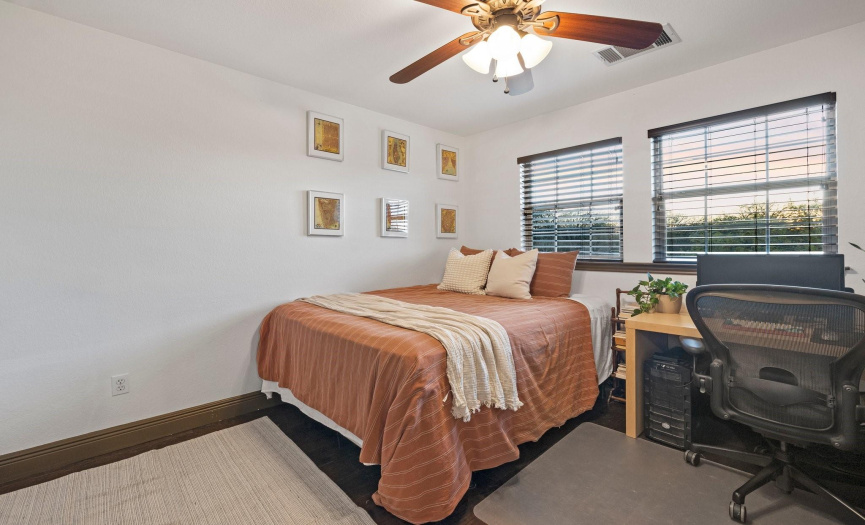The second bedroom offers a comfortable space with natural light, ideal for guests or a home office setup.