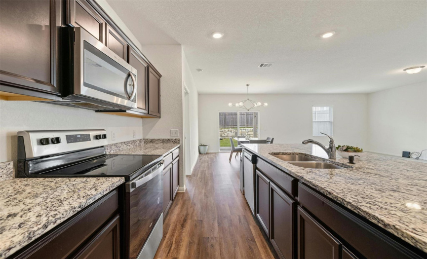 Appreciate the sleek stainless-steel appliances in the kitchen, adding a modern touch to the space while providing convenience for daily cooking tasks.