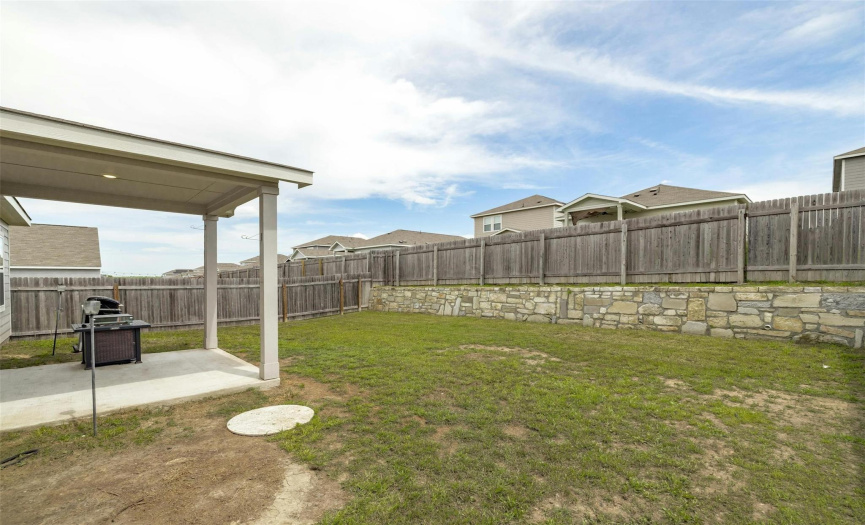 Step into the spacious backyard, offering plenty of room for outdoor activities and leisurely strolls.
