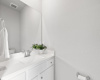 The downstairs powder room offers a practical and easily accessible space for bothresidents and guests.
