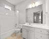 In the extra bathroom, you'll discover abundant space for your daily preparations, adorned with modern accents.