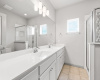 The ensuite bathroom features ample space and luxuries such as a dual vanity and large walk-in shower.