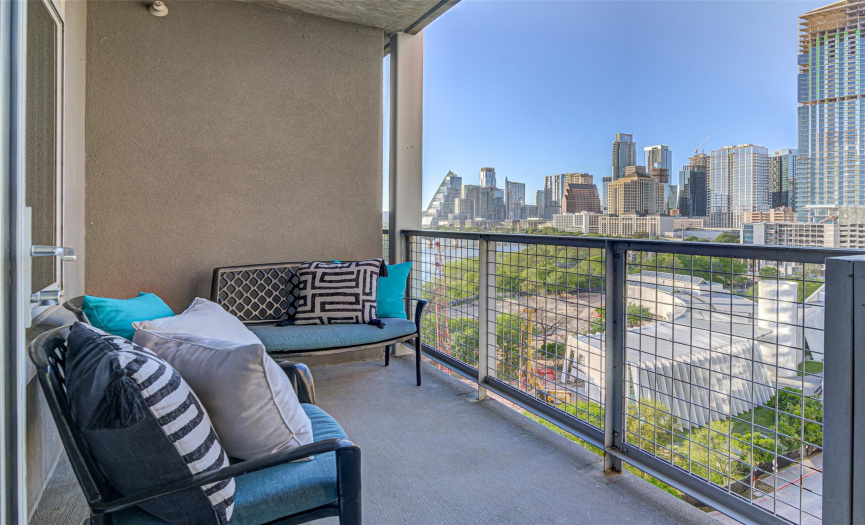 Patio #1 (of two!) directly off the main living area, provides breathtaking views of Austin skyline, it's sunsets, and the arrival of the bats, every evening.