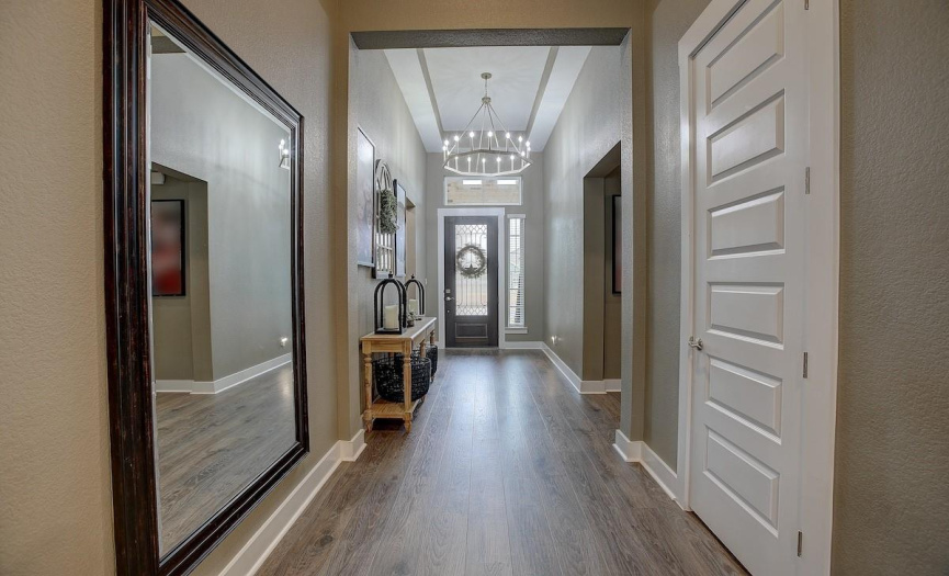 The grand entrance hallway with it's stellar lighting and large scale will welcome you into the gigantic living area