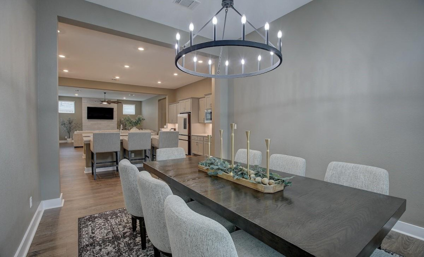 Formal dining room has tall ceilings, and upgraded lighting. Need a large table? Everyone can enjoy a seat in this large room