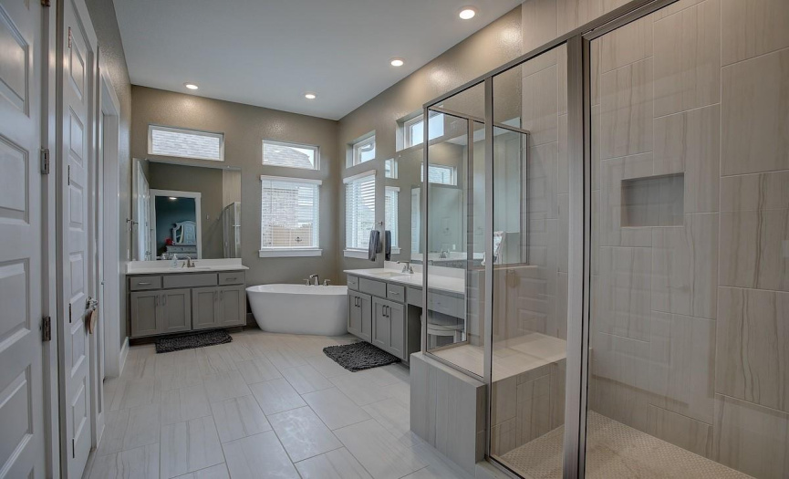 Look at this amazing bathroom! large walk in shower, slipper soaking tub, 2 vanities, potty closet, and maybe the largest most functional walk in closet ever!