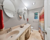Full secondary bathroom has a huge double vanity and full shower/bathtub combo.
