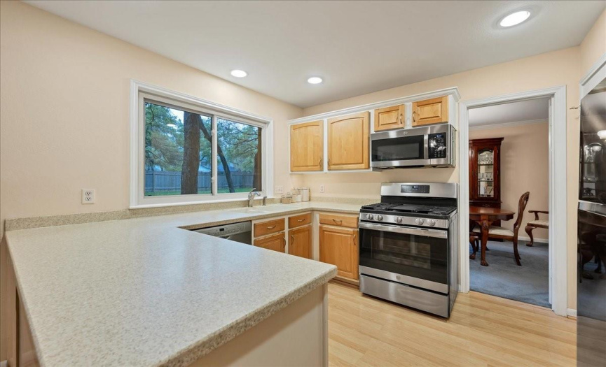 The kitchen has a large peninsula, gas range, and stainless steel appliances!