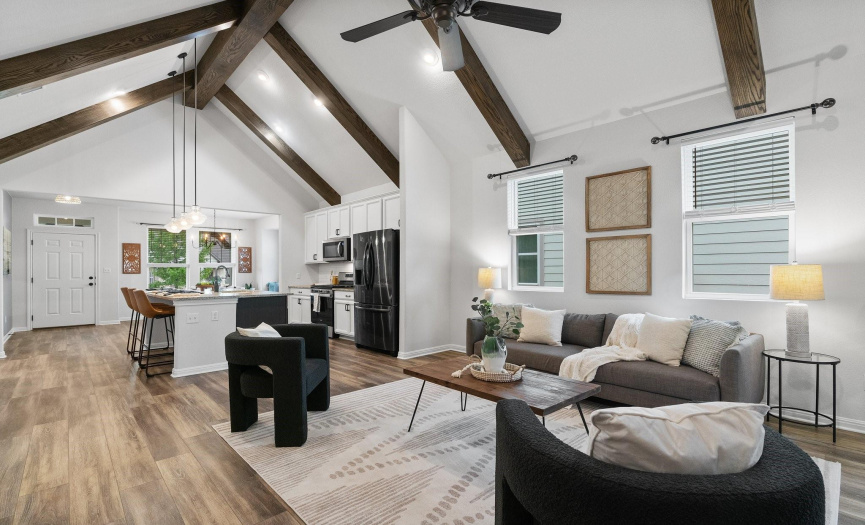 Entertain with flair in the spacious living room, boasting abundant natural light and stunning wood-look tile flooring for a touch of sophistication.