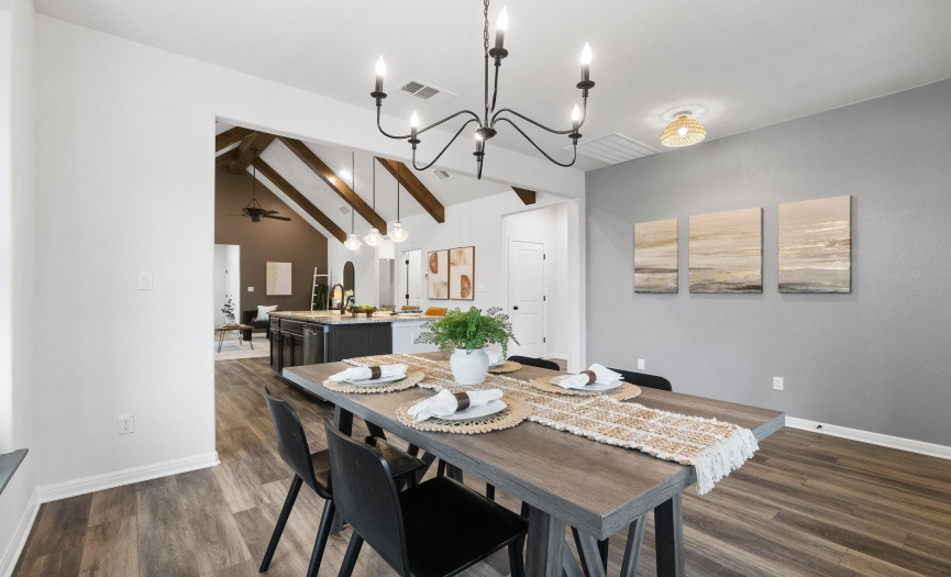 The immaculate interior features high ceilings, neutral tones, abundant natural light, and stunning wood-look tile flooring, creating an atmosphere of timeless elegance.