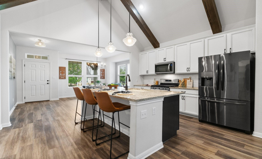 Unleash your culinary creativity in the chef's kitchen, equipped with a large center island and sleek stainless-steel appliances for gourmet cooking adventures.