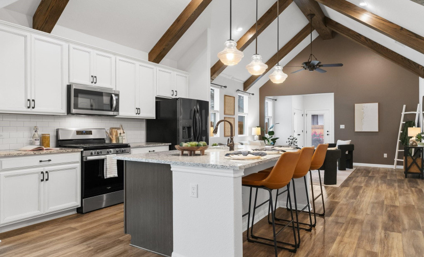 Discover the perfect blend of style and functionality in the chef's kitchen, featuring granite countertops, two-tone cabinetry, and a walk-in pantry.