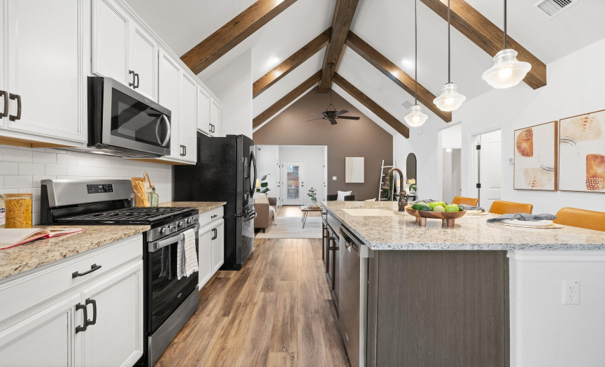 Entertain with ease in the chef's kitchen, where a breakfast bar and ample counter space provide plenty of room for mingling and meal preparation.