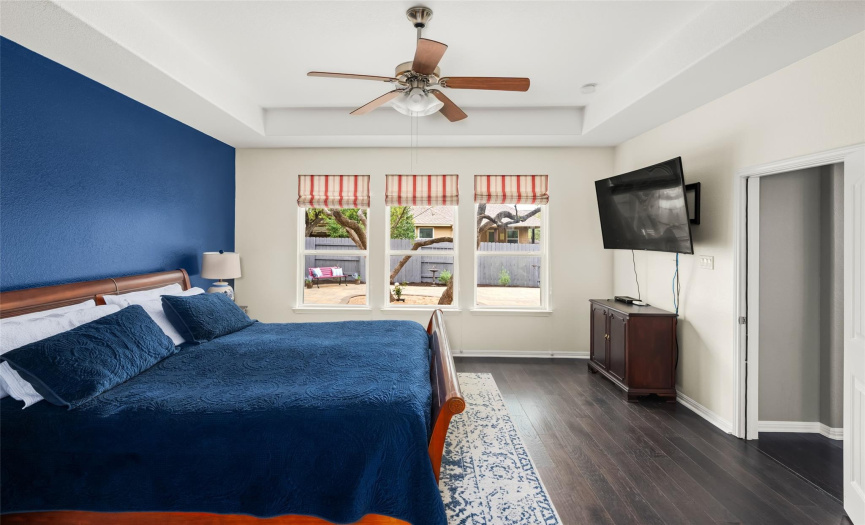 The secluded main floor primary suite serves as your peaceful getaway for rest & relaxation. Featuring  a walk-in closet, tray ceilings and windows overlooking your backyard oasis.