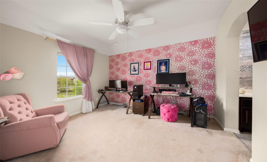The sizable secondary bedroom boasts a lovely accent wall and also offers its own private vanity area connected to the shared jack-n-jill bath.