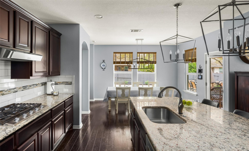 Featuring granite countertops, SS appliances, tile backsplash, a pantry, SS under-mount sink, and a sunny dining area. There is also a whole home, high efficiency water softener system.
