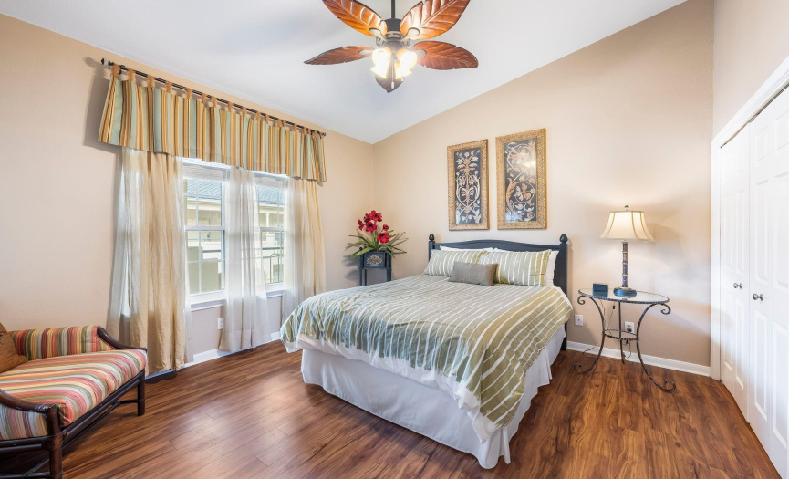Unwind in the serene ambiance of the bedrooms, each featuring vaulted ceilings, fans, and newly installed LVP flooring.