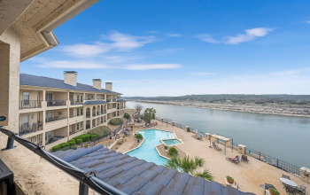 This top-floor, meticulously updated former model unit boasts unparalleled lakefront vistas of majestic Lake Travis, complemented by access to a plethora of amenities and stunning sunsets. 