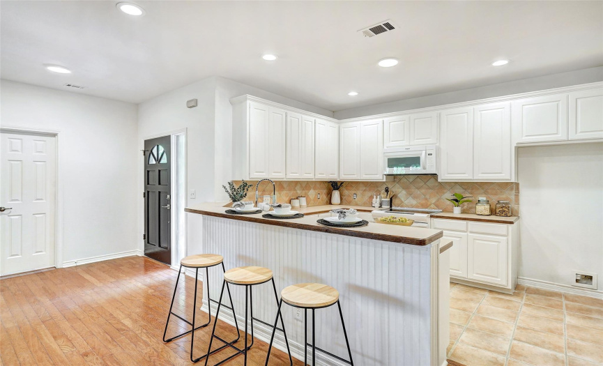 Spacious kitchen has a breakfast bar and ample counter space for food prep and entertaining