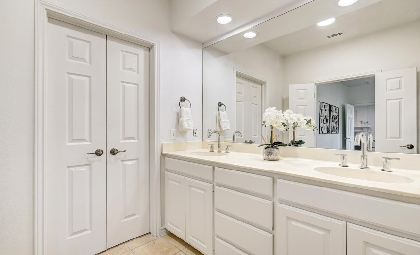 Double doors lead to the walk-in closet - enjoy a dual vanity and ample storage for all of your bath needs