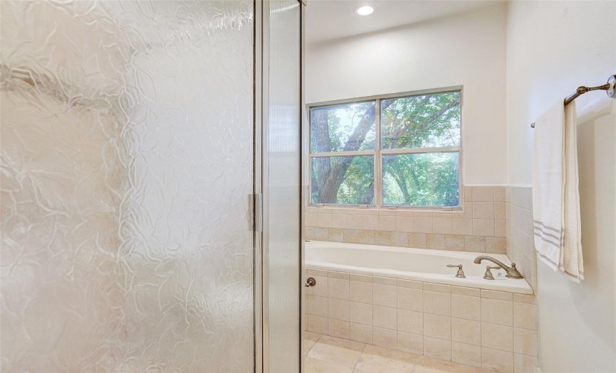 Textured shower glass for privacy - huge soaking tub has a view of the preserve
