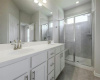 Primary ensuite bathroom, dual vanity, timeless cabinetry, a walk-in shower with bench seating