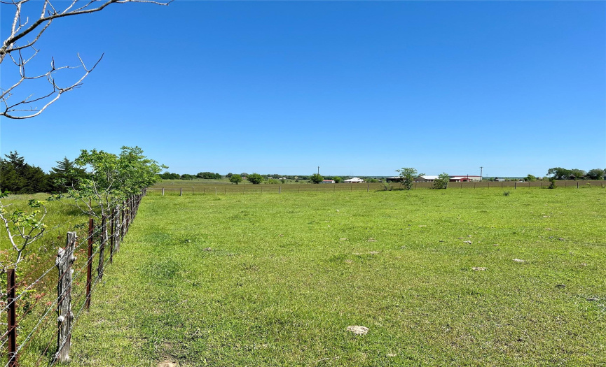 Back right corner of property shown with fence corner