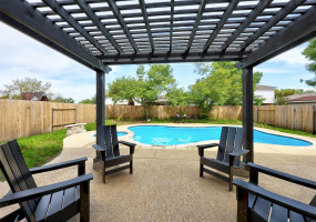 Step outside to the inviting patio, perfect for alfresco dining or lounging in the shade of the pergola.