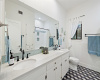 Remodeled full bathroom located on the lower level servicing the secondary bedrooms. 