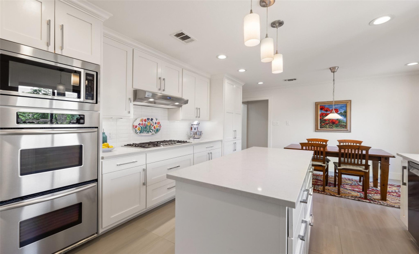 Double ovens and stainless steel appliances make this a chef's dream kitchen.