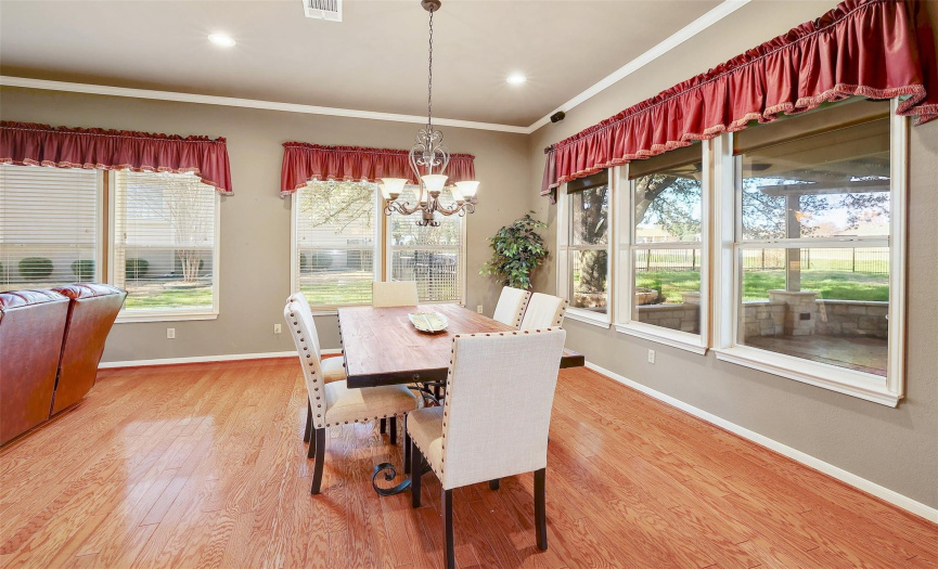 Large windows provide lovely views of the backyard and greenbelt while enjoying meals with family and friends.