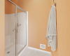 The large walk-in shower in the primary bathroom provides a refreshing bathing experience.