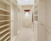 Organize your wardrobe in the custom walk-in closet, offering ample storage space for clothing and accessories.