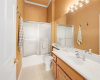 Convenient full guest bath designed for practicality with an extended vanity and a glass-enclosed tub/shower combo.