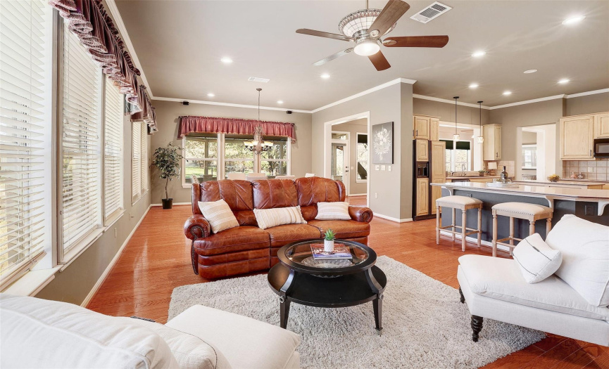 Gather around and enjoy quality time with family and friends in this spacious yet cozy area that seamlessly connects to the kitchen and dining spaces.