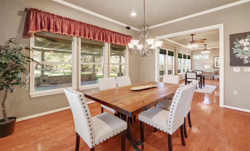 The adjacent dining area offers a perfect setting for formal meals or casual dining, with easy access to the kitchen and sunroom.