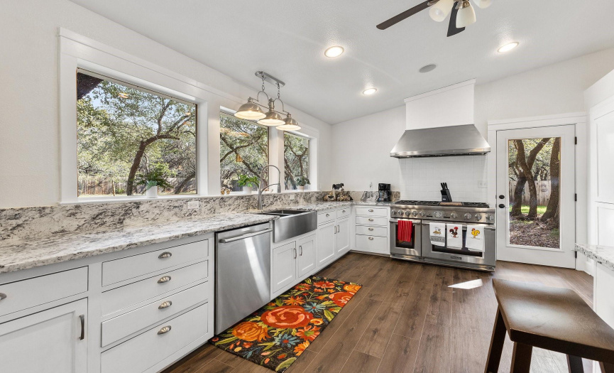 View the beautiful back yard and keep a watchful eye on kids while you cook. Italian Verona 6 burner gas range. Deep farmhouse stainless sink. A view of this stunning kitchen without the small breakfast table and chairs.