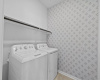 Modern wall paper has been added to the roomy laundry room. 