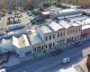 Arial view from Chestnut - the main drag through downtown Bastrop. Note the ample parking provided by the city parking lot behind these historic buildings. Just announced the property next door will be home to the showroom for a well established art foundry.