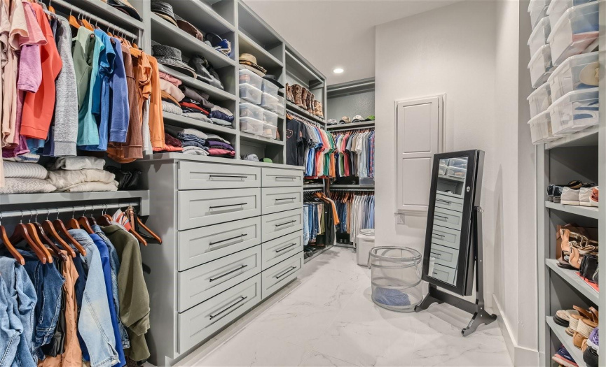 Discover the ultimate convenience in the expansive walk-in closet, meticulously designed with custom storage solutions to accommodate your every need.