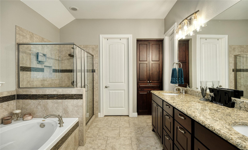 primary bathroom, double vanity, granite countertops, soaking tub, shower, walk in closets