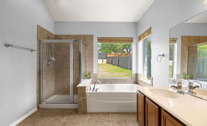 Soaking tub and separate walk-in shower.
