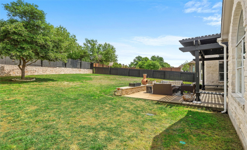 Extended patio with pergola area is a nice spot to relax and watch the kids, pets, or wildlife play.
