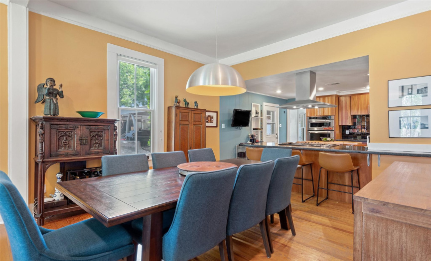 The dining room is bright with a stylish overhead light fixture and easy access to the kitchen.