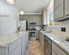 The gourmet kitchen features granite countertops, pendant lighting and stainless steel appliances