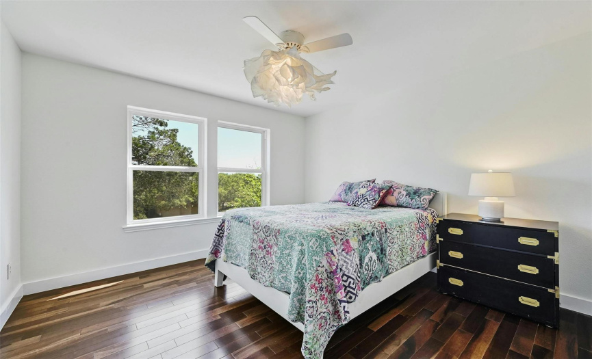 Spacious secondary bedrooms with an abundance of natural light and wood floors 