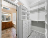 Walk in closet has variety of shelves, drawers, and hanging areas to accommodate your needs.  